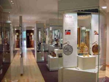 Museum gallery with clocks displayed in cases